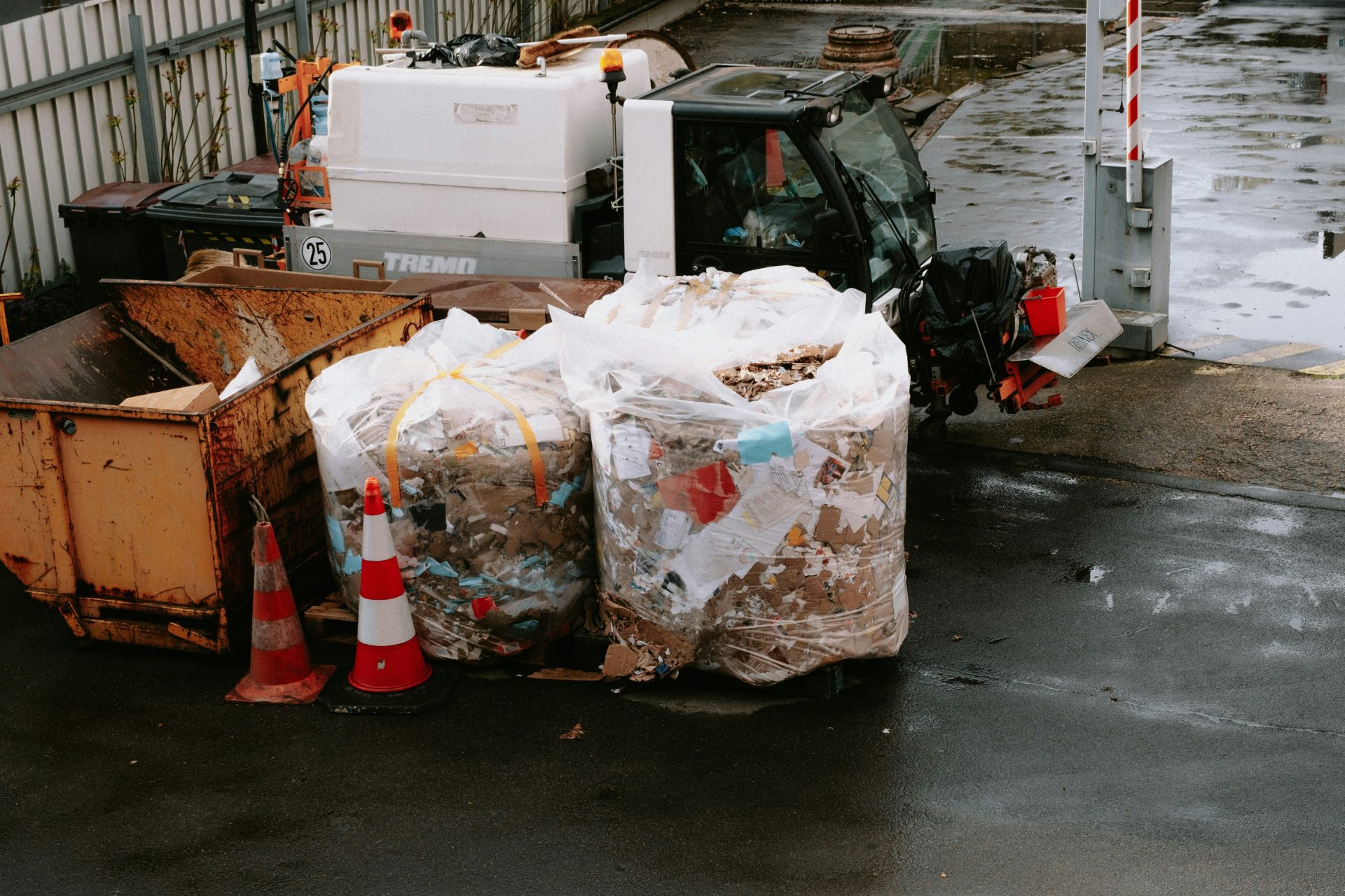 a dump truck parked next to a pile of garbage
