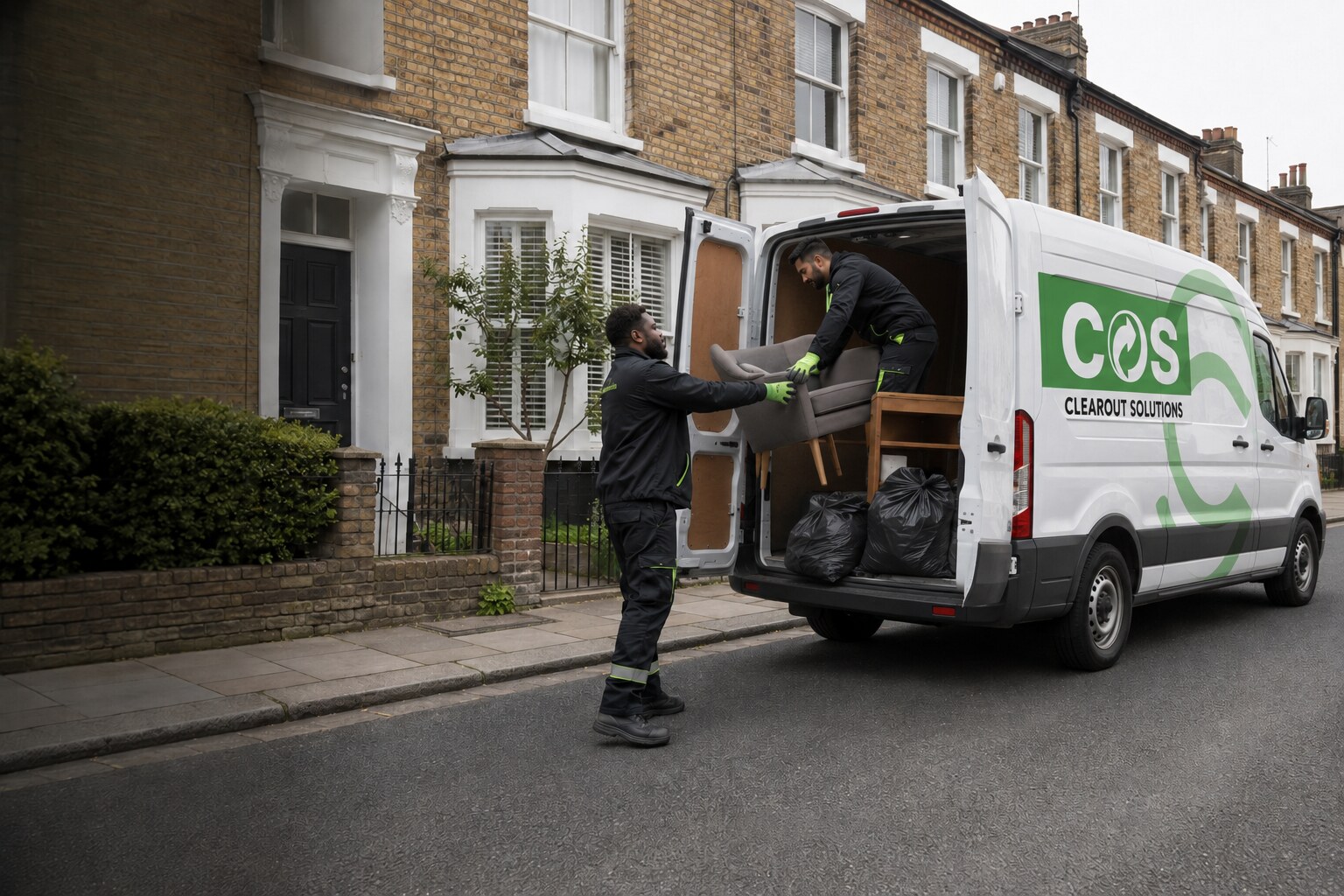 ClearOut Solutions crew loading household items into a branded collection van in London.